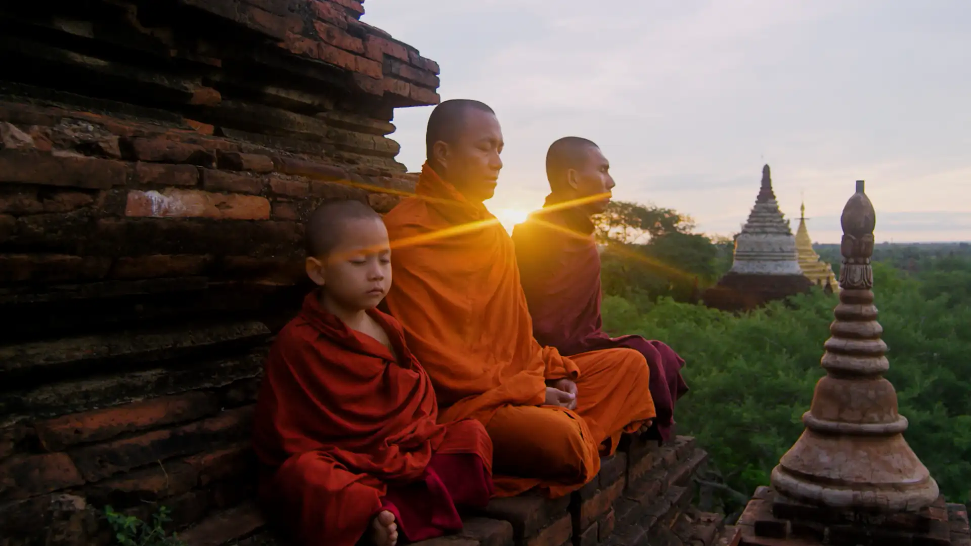 Monks meditating at sunrise